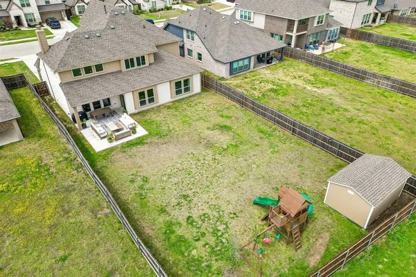 a aerial view of residential houses with yard