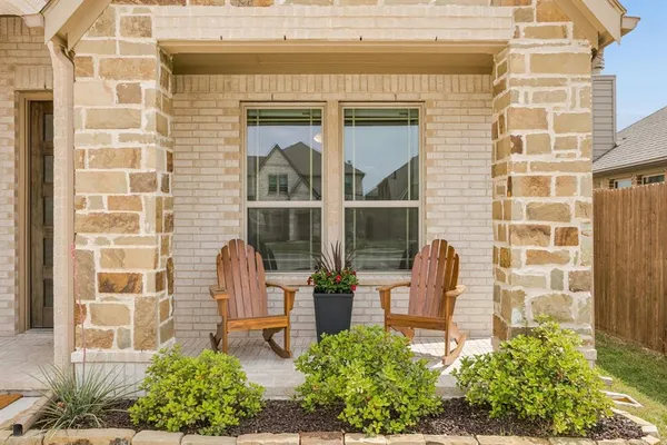 a front view of a house with outdoor seating and plants