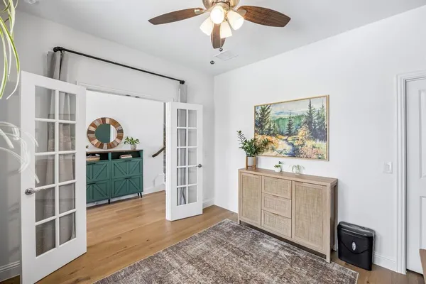 a view of empty room with wooden floor and window