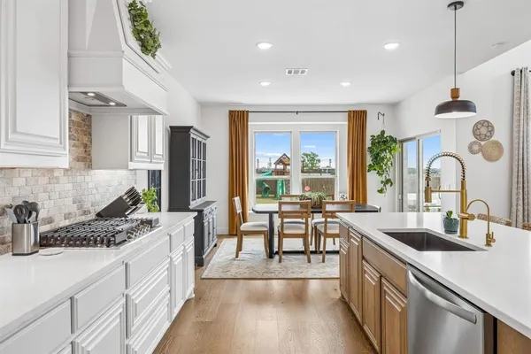 a kitchen with sink stove and cabinets