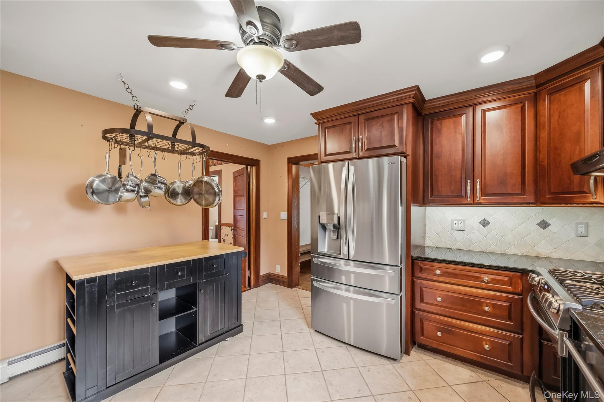 328 Big Island Road Florida, NY 10921 - Photo 14 of 40 Kitchen with wood cabinetry, stainless steel appliances, tile flooring and additional storage space.