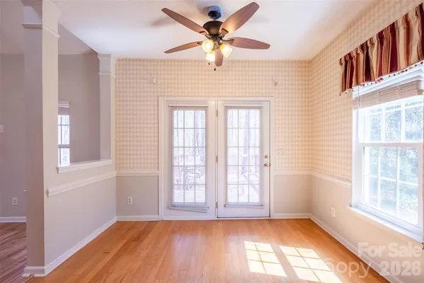 wooden floor in an empty room with a window