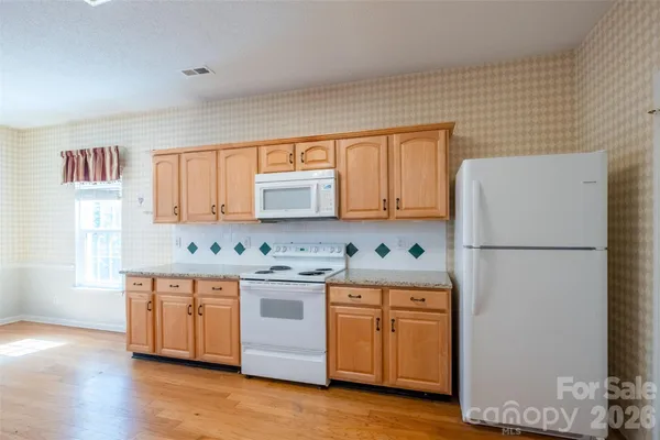 a kitchen with stainless steel appliances a refrigerator sink and cabinets