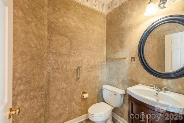a bathroom with a sink a toilet and a mirror