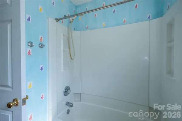 a bathroom with a shower and a bath tub