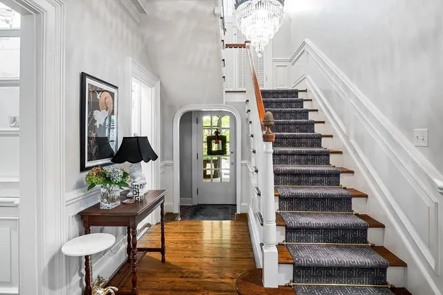 a living room with furniture and a chandelier