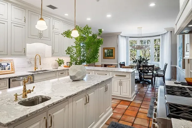 a living room with furniture a chandelier and a fireplace