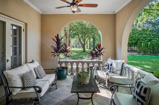 a room with lots of white furniture and a wooden floor