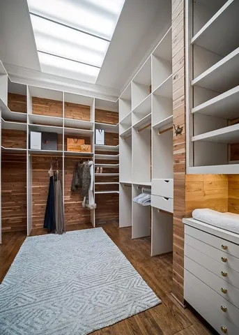 a view of a table and chairs under an umbrella in the garden