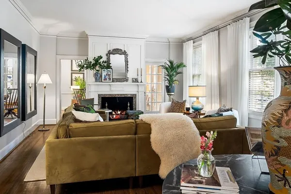 a kitchen with stainless steel appliances kitchen island granite countertop a table chairs in it and white cabinets