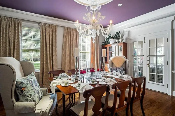 a kitchen with stainless steel appliances granite countertop a sink dishwasher a stove and white cabinets with wooden floor
