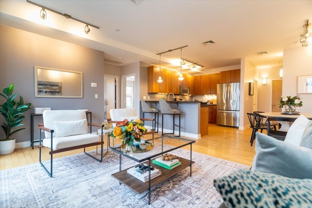 24 Bay State Road, Unit 18 Cambridge, MA 02138 - Photo 1 of 27 a living room with furniture and kitchen view