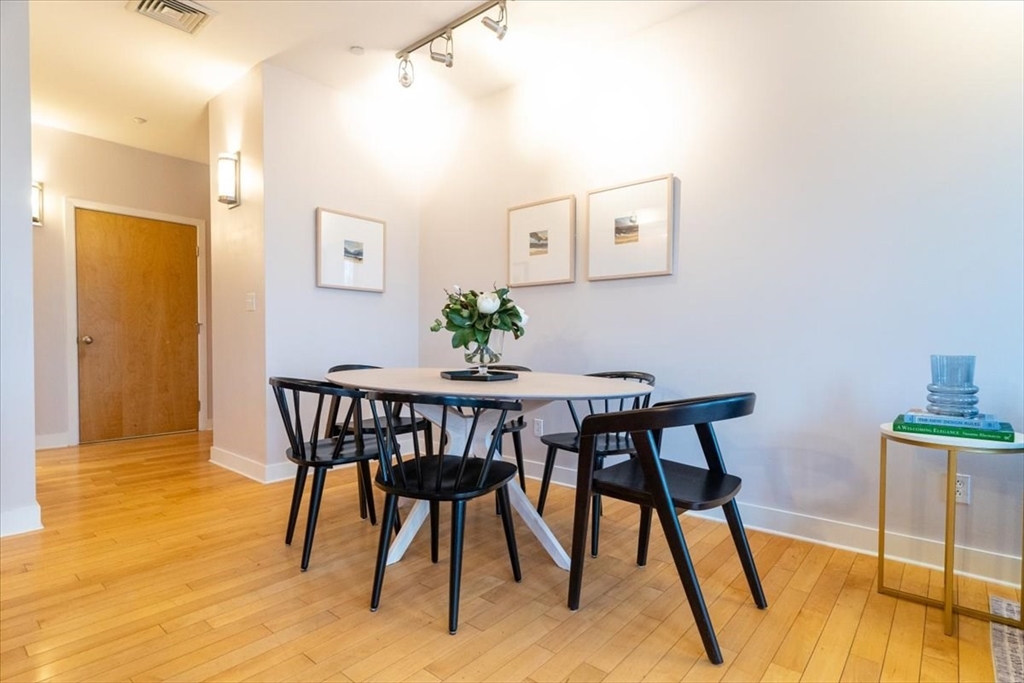 24 Bay State Road, Unit 18 Cambridge, MA 02138 - Photo 11 of 27 a view of a dining room with furniture and wooden floor
