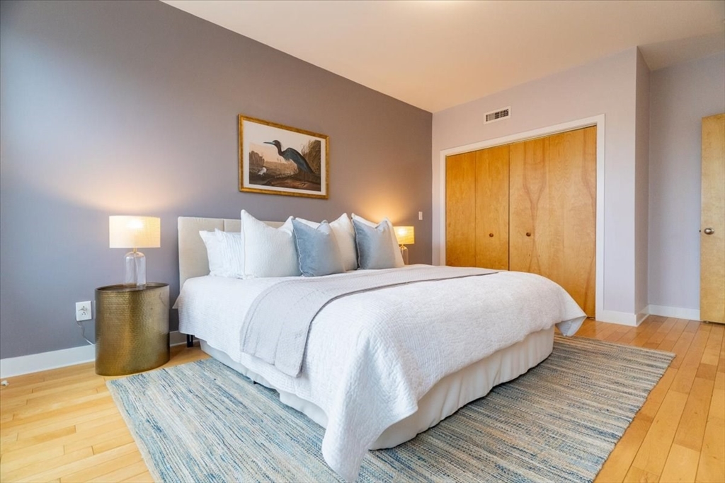 24 Bay State Road, Unit 18 Cambridge, MA 02138 - Photo 13 of 27 a bedroom with a bed and wooden floor