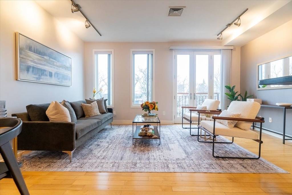 24 Bay State Road, Unit 18 Cambridge, MA 02138 - Photo 2 of 27 a living room with fireplace furniture and a rug