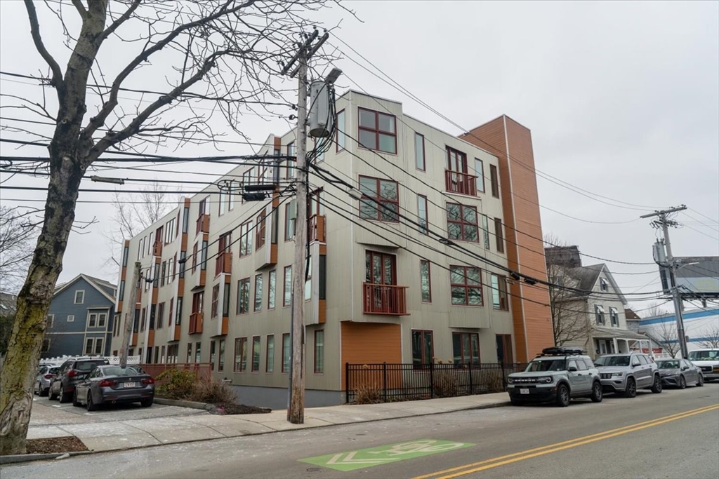 24 Bay State Road, Unit 18 Cambridge, MA 02138 - Photo 21 of 27 a city street lined with parked cars front of buildings