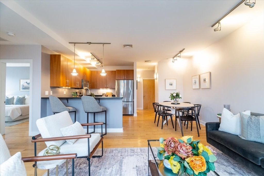 24 Bay State Road, Unit 18 Cambridge, MA 02138 - Photo 3 of 27 a living room with dining room and kitchen view