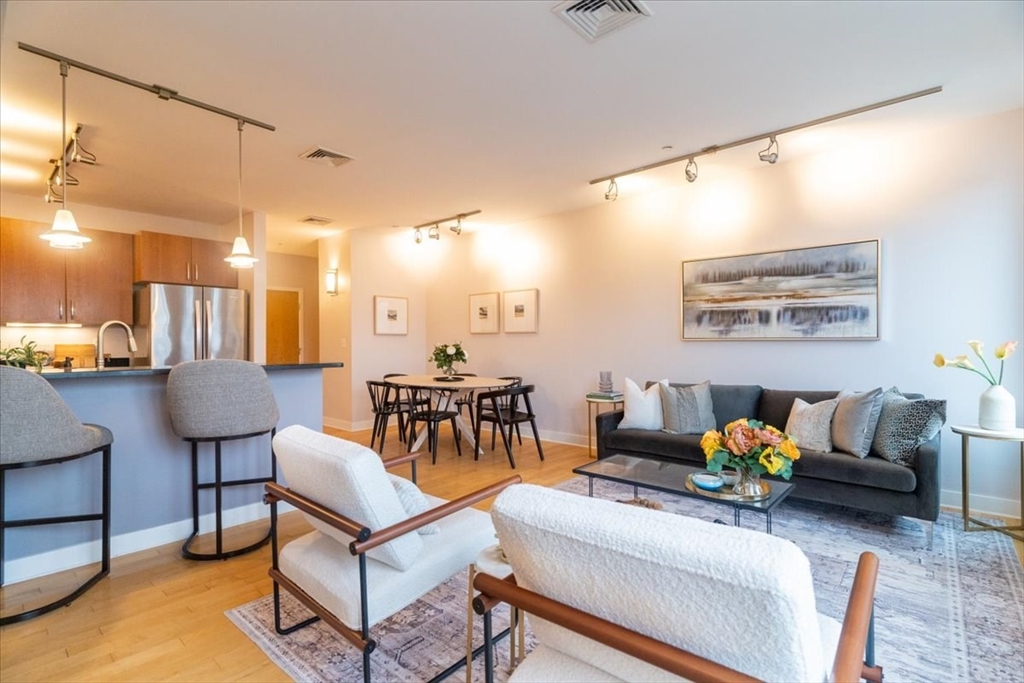 24 Bay State Road, Unit 18 Cambridge, MA 02138 - Photo 4 of 27 a living room with furniture a table and a potted plant