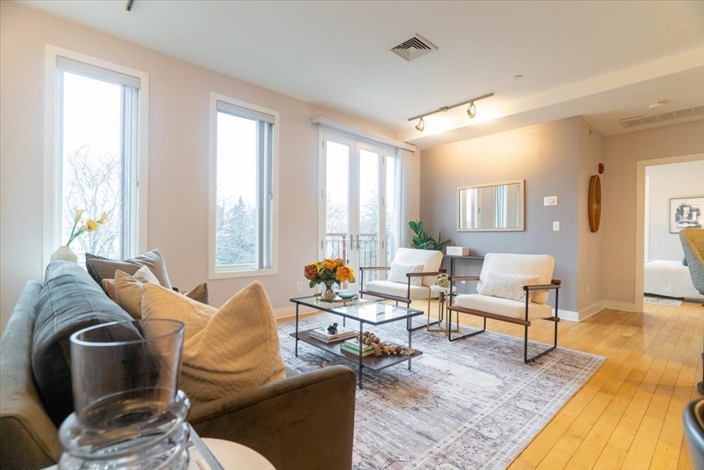 24 Bay State Road, Unit 18 Cambridge, MA 02138 - Photo 5 of 27 a living room with furniture and wooden floor