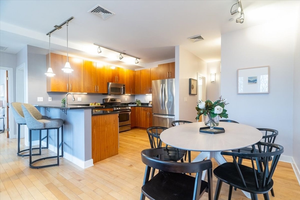 24 Bay State Road, Unit 18 Cambridge, MA 02138 - Photo 7 of 27 a view of a dining room with furniture and wooden floor
