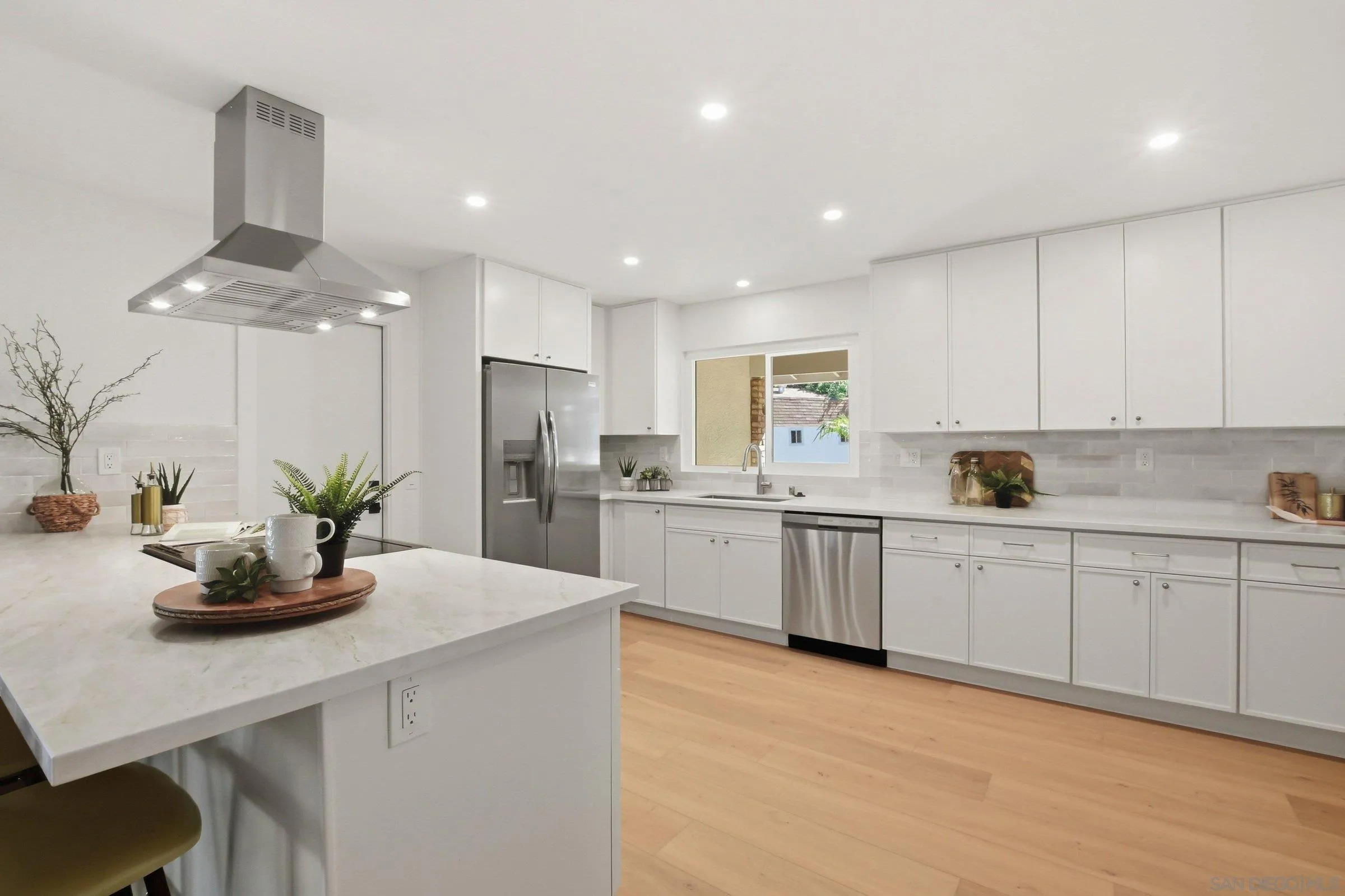 646 Barsby Street Vista, CA 92084 - Photo 1 of 48 a kitchen with a sink stainless steel appliances and white cabinets