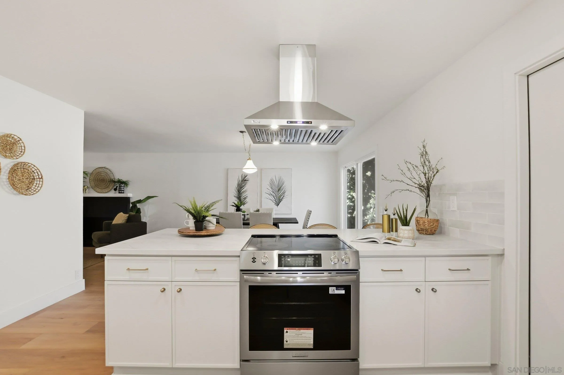 646 Barsby Street Vista, CA 92084 - Photo 15 of 48 a kitchen with a sink stove and cabinets