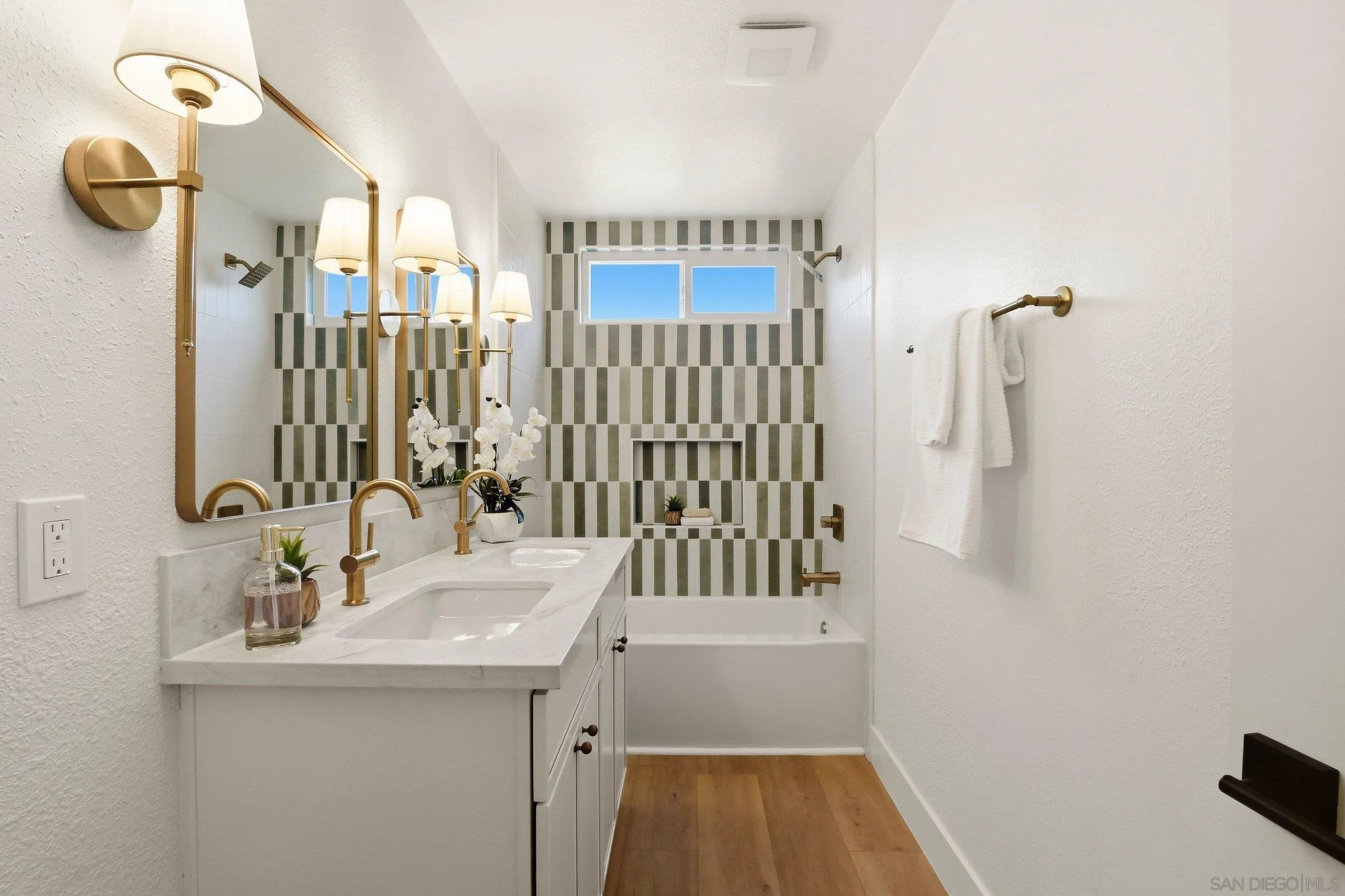 646 Barsby Street Vista, CA 92084 - Photo 3 of 48 a bathroom with a sink a mirror and shower