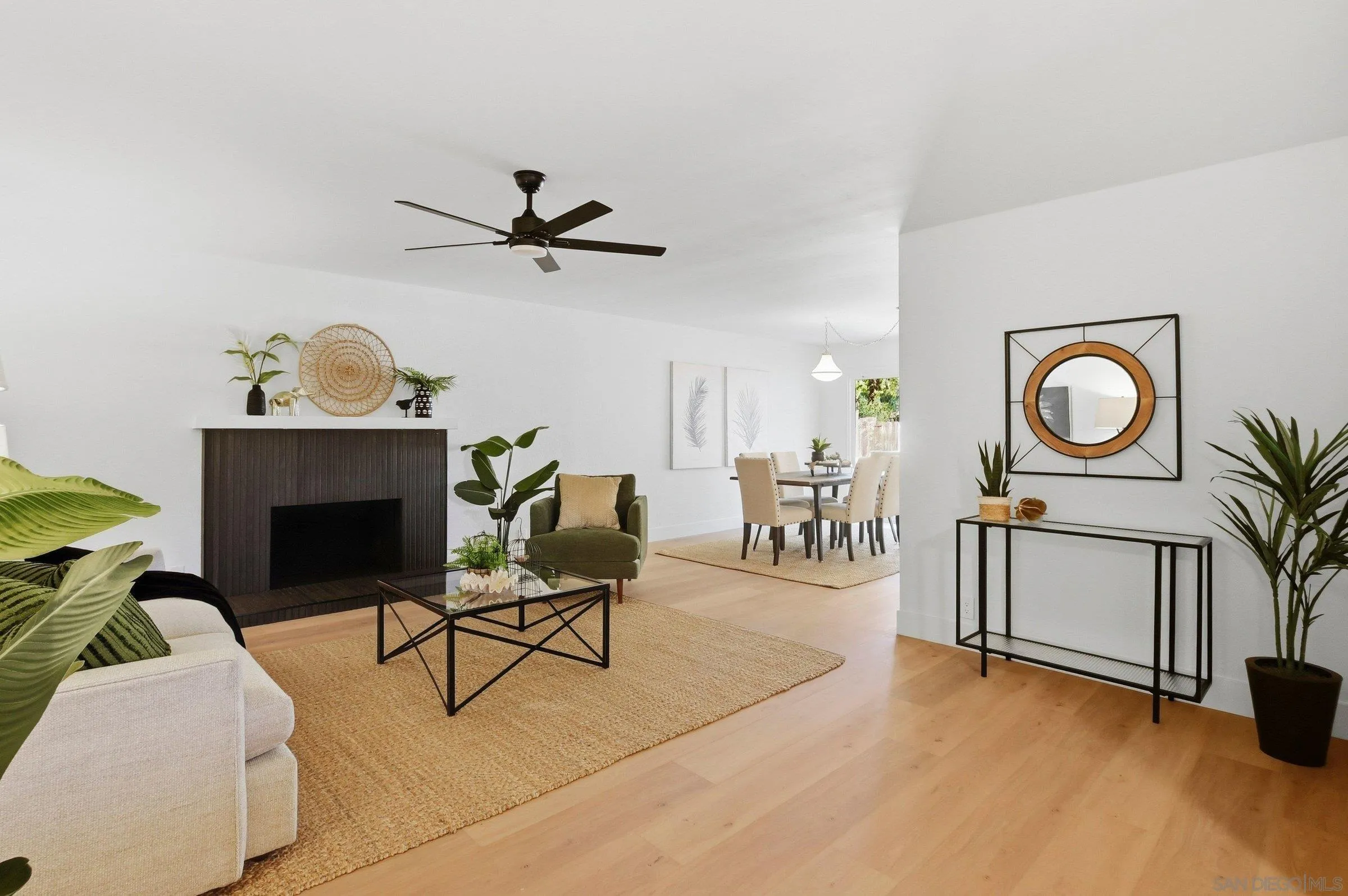 646 Barsby Street Vista, CA 92084 - Photo 4 of 48 a living room with furniture a chandelier and a fireplace