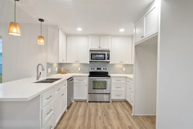 a kitchen with a sink stove and cabinets