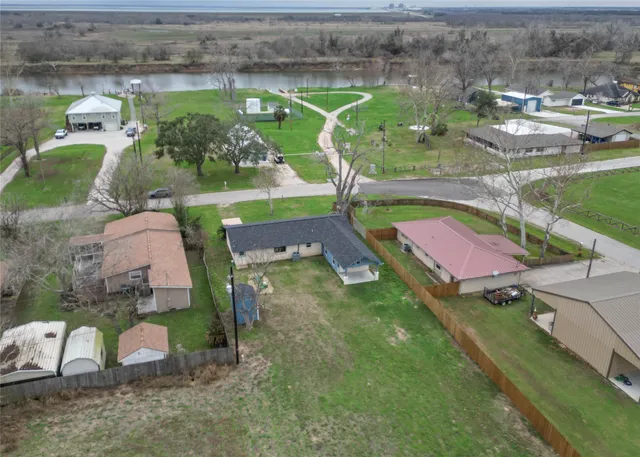 an aerial view of a house with a yard basket ball court and outdoor seating