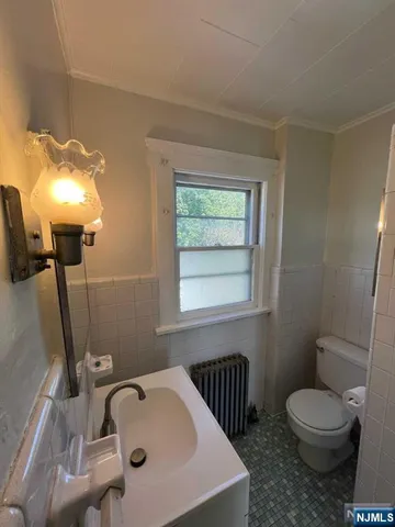 a bathroom with a sink a toilet and bathtub