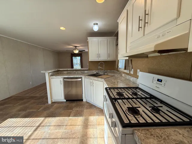 a kitchen with a stove top oven and cabinets