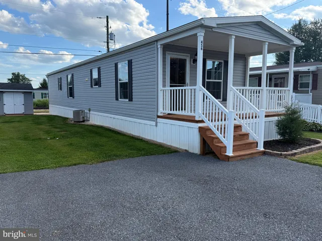 a view of a house with a yard and deck