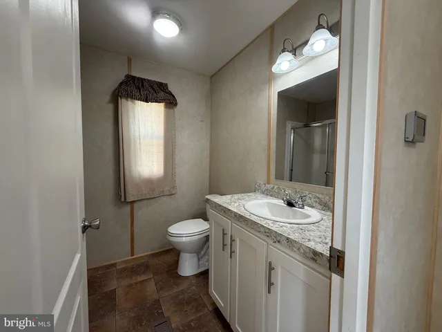 a bathroom with a glass shower door