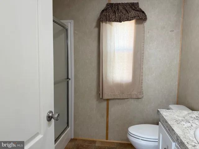 a kitchen with white cabinets sink and stainless steel appliances