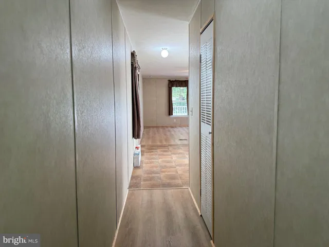 a kitchen with granite countertop a refrigerator sink and cabinets