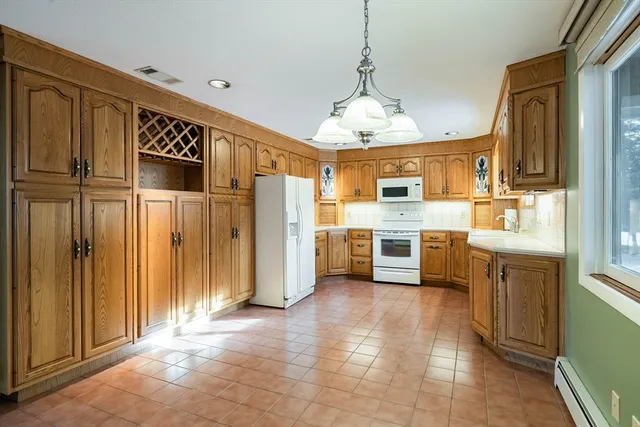 a kitchen with stainless steel appliances a refrigerator a stove a sink dishwasher and wooden cabinets