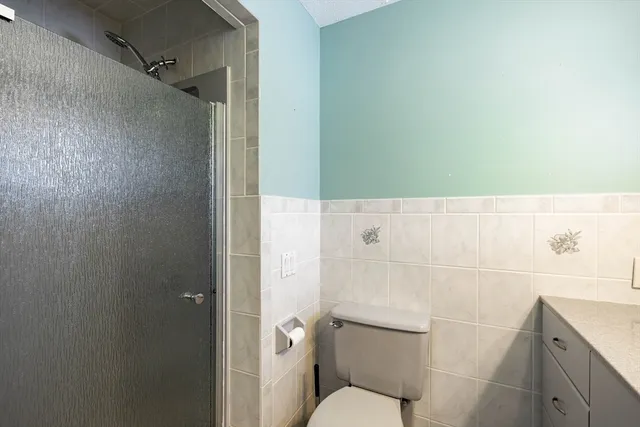 a bathroom with a toilet and a shower