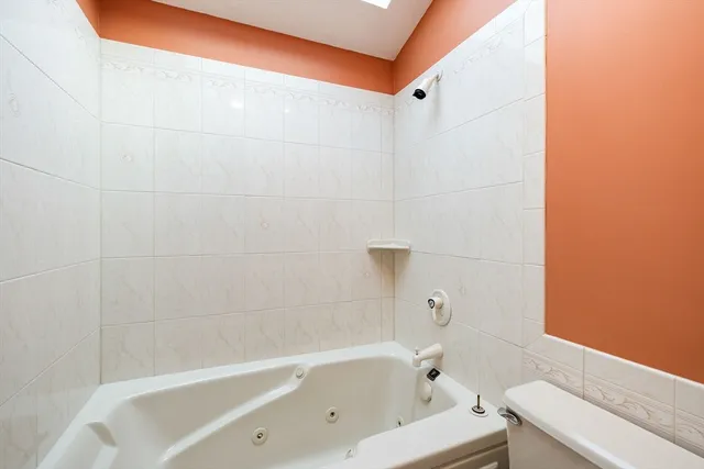 a bathroom with a bathtub and a toilet