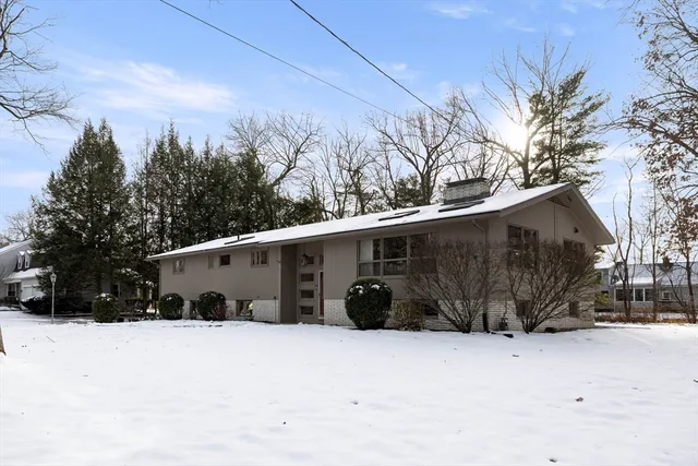 a view of a house with a snow in the yard