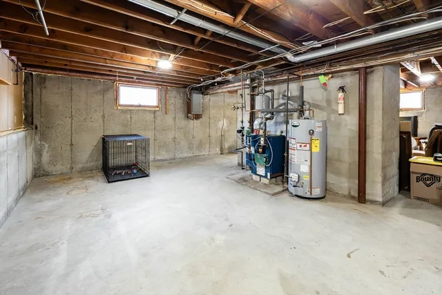 a view of water heater room with refrigerator