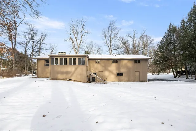 a view of a house with snow on the road