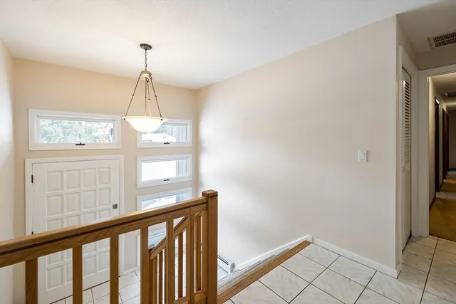 a view of a hallway with windows