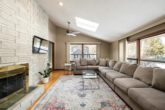 a living room with furniture flat screen tv and a fireplace