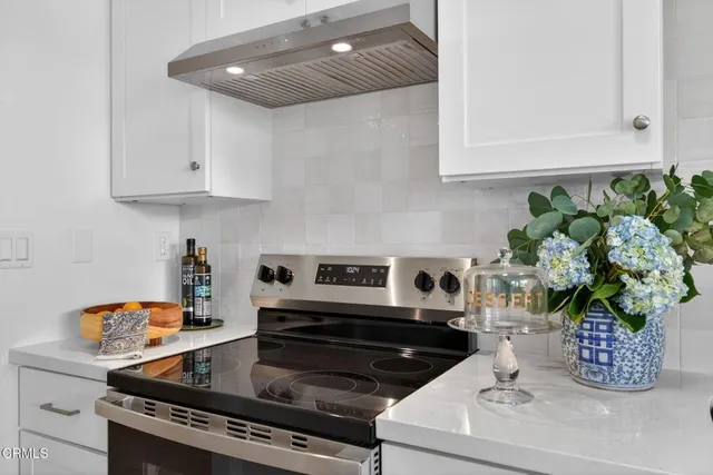 a kitchen with a stove and cabinets