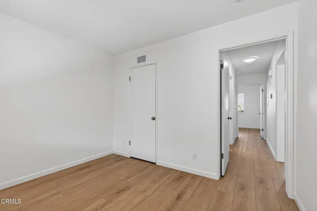 a view of a room with wooden floor