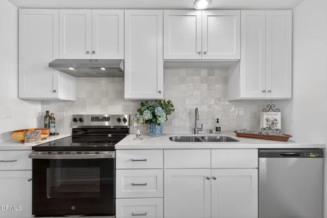 a kitchen with a sink stove and cabinets