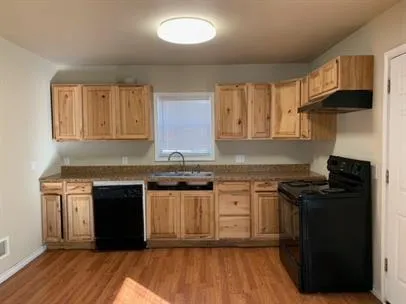 a kitchen with a sink stove and cabinets