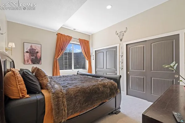 a living room with furniture a rug and white walls