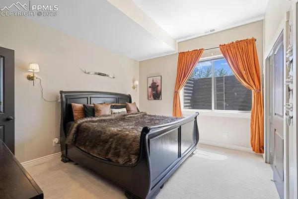 a bedroom with bed and a large mirror